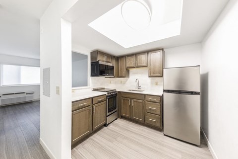 a kitchen with wooden cabinets and stainless steel appliances